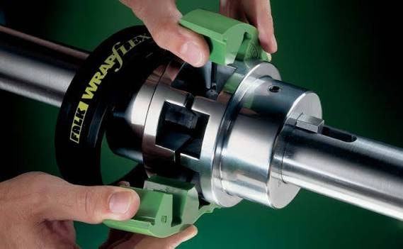 Hands installing a Falk Wrapflex coupling onto a mixer shaft